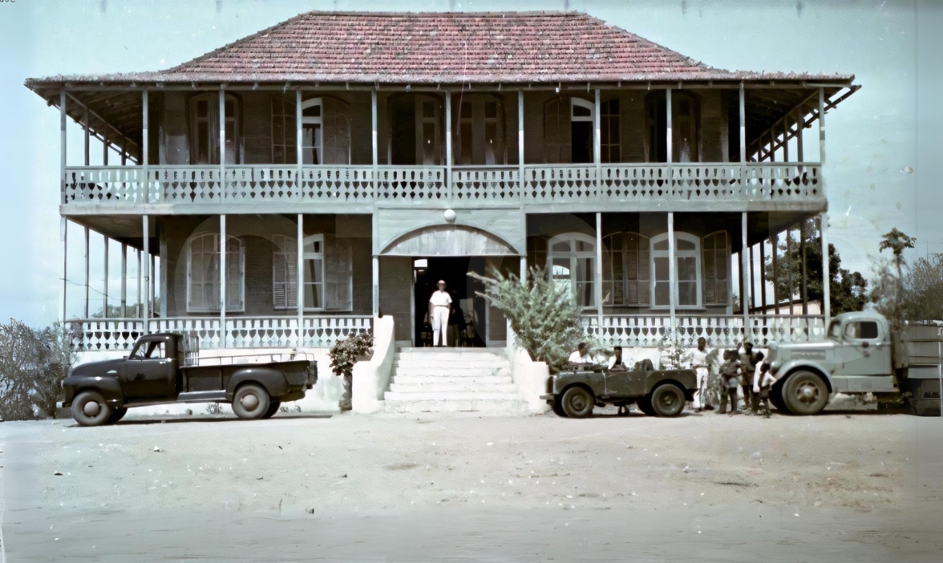 Historic building with Land Rovers parked in front