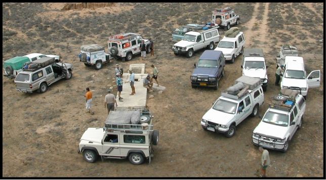 Archival black-and-white photograph of a Land Rover and soldiers in Angola